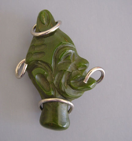 BAKELITE green swirl carved native face brooch