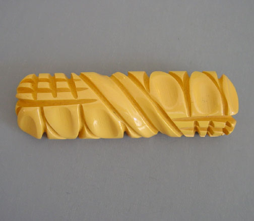 BAKELITE medium yellow carved bar brooch