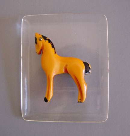 BAKELITE overdyed horse on Lucite brooch
