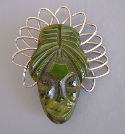 BAKELITE carved green swirl native exotic face brooch