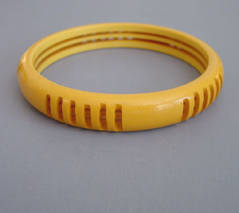BAKELITE yellow carved and pierced bangle