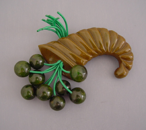 BAKELITE green swirl carved cornucopia brooch