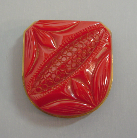 BAKELITE red carved dress clip with brass backing