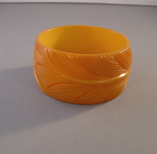 BAKELITE wide butterscotch bangle, leaf carved