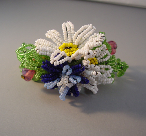 HATTIE CARNEGIE bracelet, a hinged style with a floral bouquet