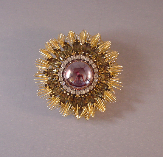 KRAMER starburst brooch with a gray cabochon center