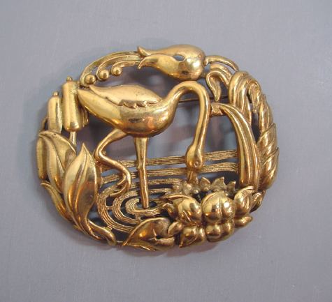 CRANE in a landscape brooch in gold tone