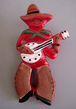 Shultz bakelite red smiling guitar-playing cowboy pin