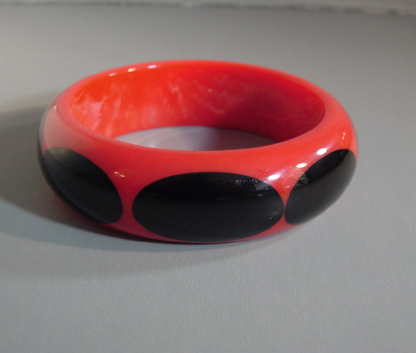 SHULTZ bakelite rosy red bangle with eight black dots