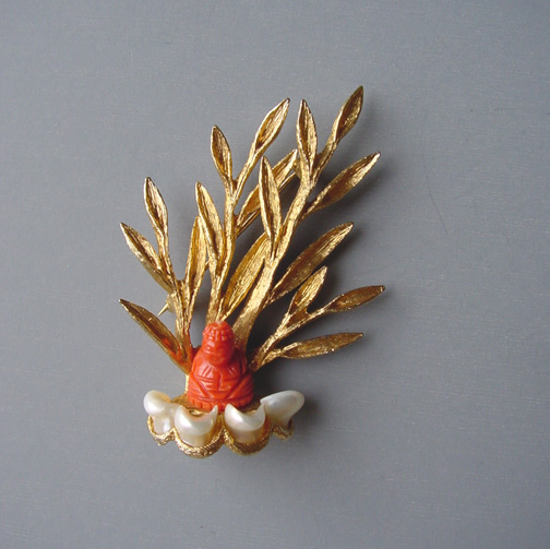 SWOBODA carved coral Buddha brooch
