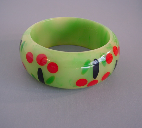 SHULTZ bakelite green swirl bangle with cherry motif in red, black and green