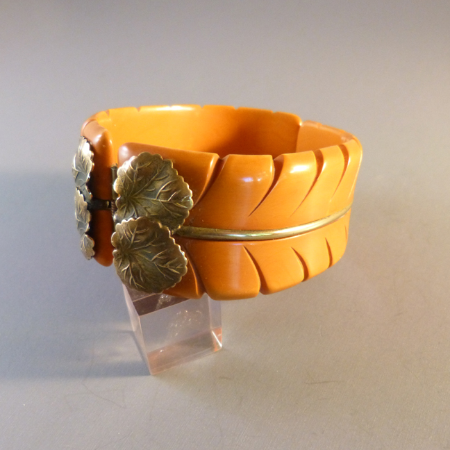 BAKELITE butterscotch hinged clamper bangle, applied brass