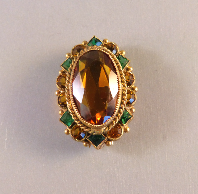 FUR CLIP with a center oval caramel colored faceted rhinestone