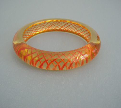 SHULTZ bakelite apple juice bangle with orange reverse carved