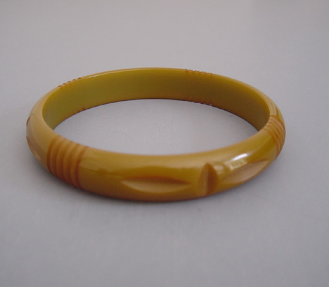 BAKELITE butterscotch bangle with leaf slash carving