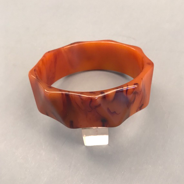 BAKELITE flame colored bakelite bangle carved in large triangle facets