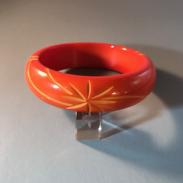 BAKELITE orange marmalade overdyed bangle with a starburst carving