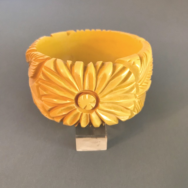 BAKELITE chunky corn colored bangle with deeply carved flowers