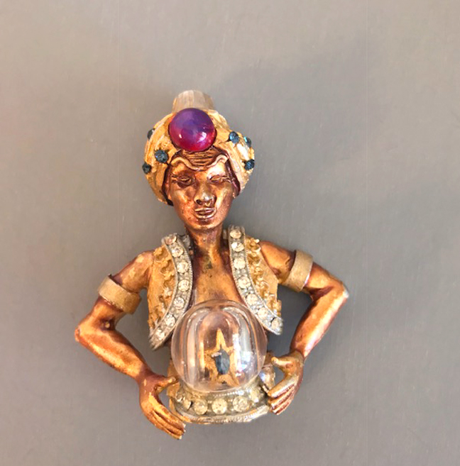 HAR figural genie brooch with a glass “crystal” ball