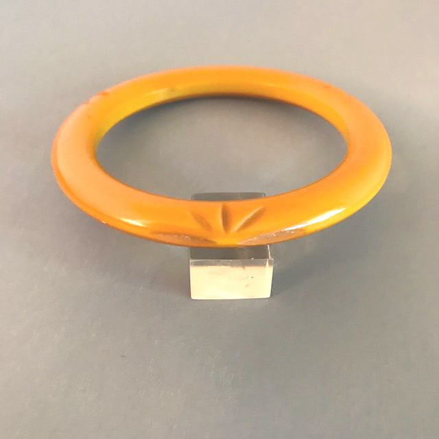 BAKELITE butterscotch spacer bangle with three carved starbursts