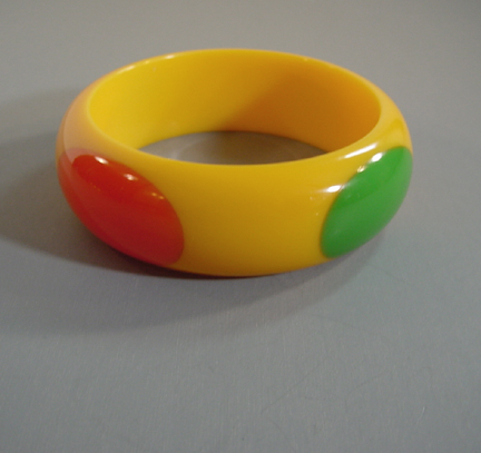 SHULTZ bakelite yellow bangle with red, green and black dots