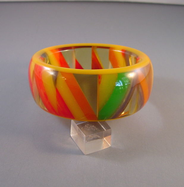 SHULTZ bakelite checked bangle with yellow outer bands, apple juice, and marbled yellow, red, orange, blue and green