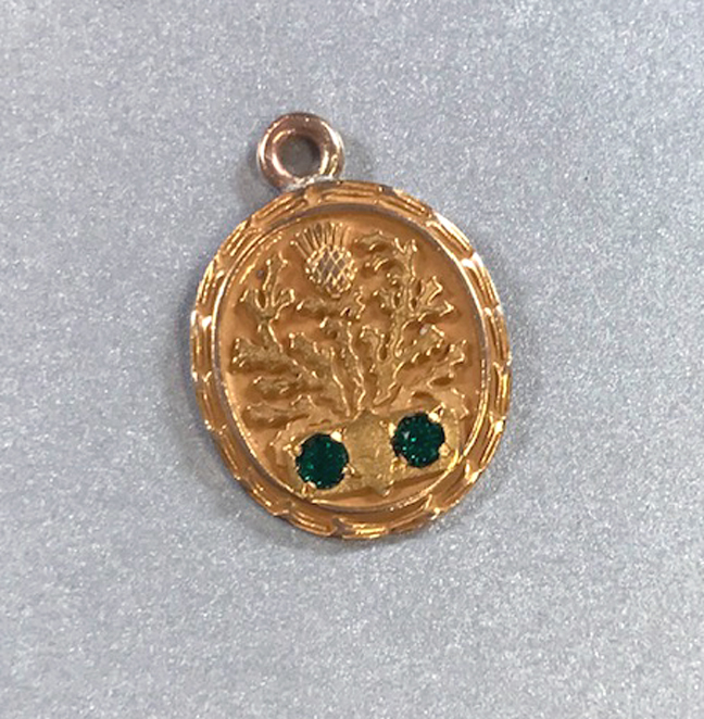 CHARM 10 karat yellow gold thistle charm with two green faceted stones
