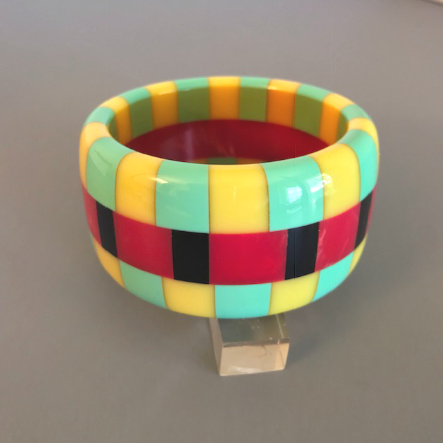 SHULTZ bakelite three row check bangle with red and black center row checks and yellow and green checked