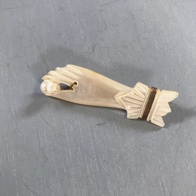 VICTORIAN mother-of-pearl hand pin holding a pearl