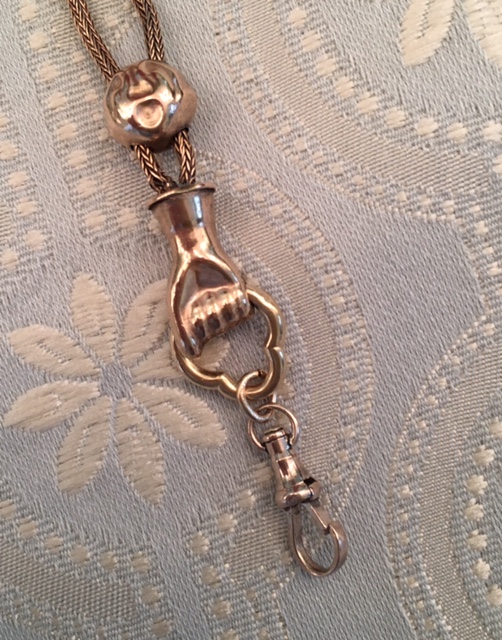 VICTORIAN gold tone slide chain necklace with a hand in a fist holding the hook