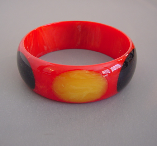 SHULTZ bakelite red bangle with black and yellow marbled dots