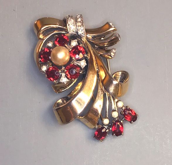 DEROSA fur clip with gold washed sterling flower and ribbons and red rhinestone petals and drops, a glass pearl center