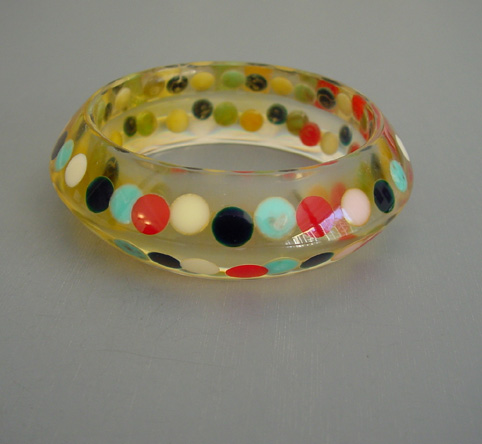 SHULTZ bakelite apple juice saucer bangle with lots of colorful confetti dots
