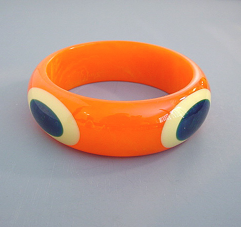 SHULTZ bakelite orange bangle with cream and blue moon bull’s eye oval dots