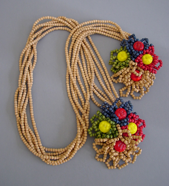 MIRIAM HASKELL rare floral lariat necklace of colored and natural wood and glass beads in red, blue, yellow and green with bright red and yellow glass buttons