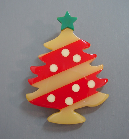 SHULTZ bakelite Christmas tree brooch in red and pale yellow stripes with white ornaments and a teal green star