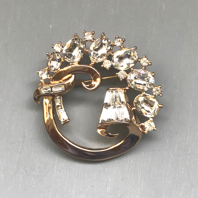 TRIFARI circle brooch with clear baguettes and round rhinestones set in gold tone metal