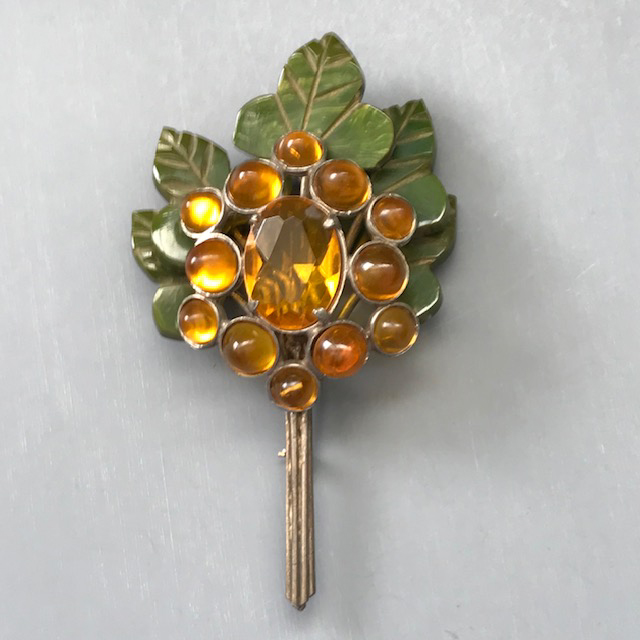 BLUMENTHAL flower bouquet brooch made of bakelite leaves and honey colored glass collet set cabochons