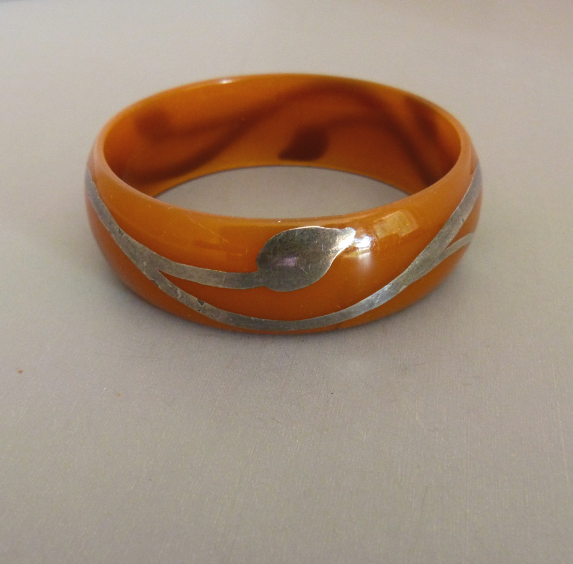 CELLULOID translucent butterscotch bangle with silver overlay in a buds and scrolls design