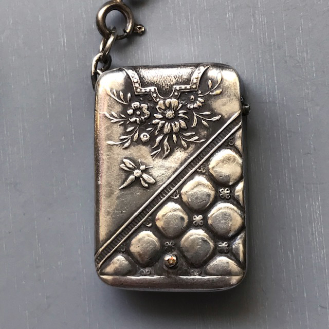 CHATELAINE silver stamp box embossed with a butterfly, flowers, and a pebbled design