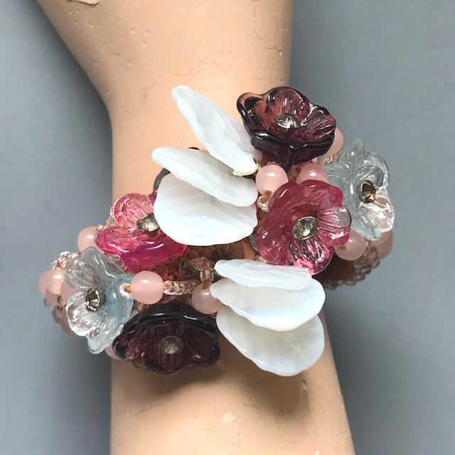 MIRIAM HASKELL spectacular Frank Hess designed pink glass beads coil bracelet with pressed glass flowers in pink, purple and blue and milk glass leaves