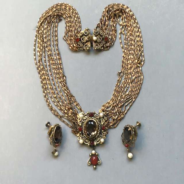 HOBE necklace and earrings with an oval brown unfoiled rhinestone center with half-bullet shaped carnelian colored accents and glass pearls at each corner