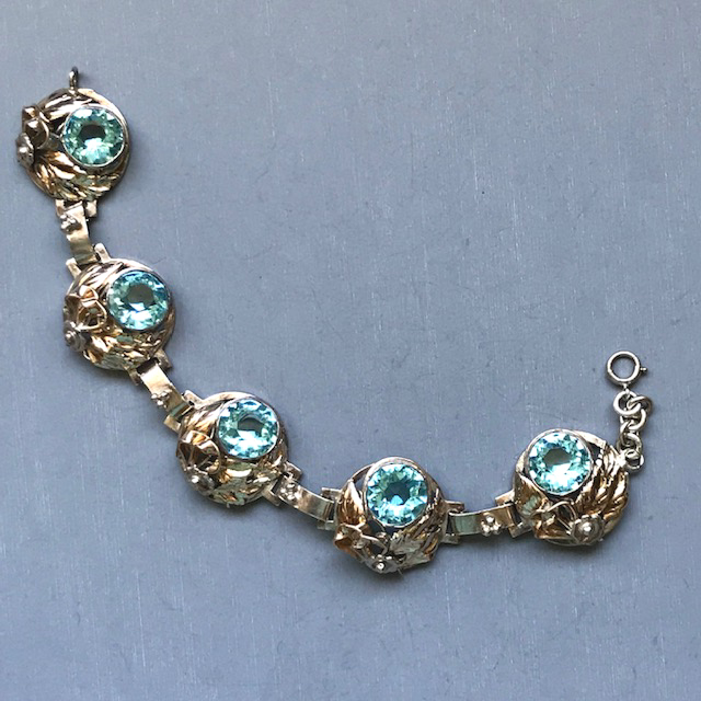 HOBE sterling silver and aqua rhinestone bracelet with each of the five round links decorated with hand made flowers, leaves and ribbons