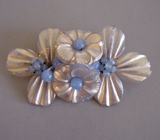 MIRIAM HASKELL rare brooch by designer Frank Hess, it has silvery pearlized pressed glass rippled petals and blue glass beads
