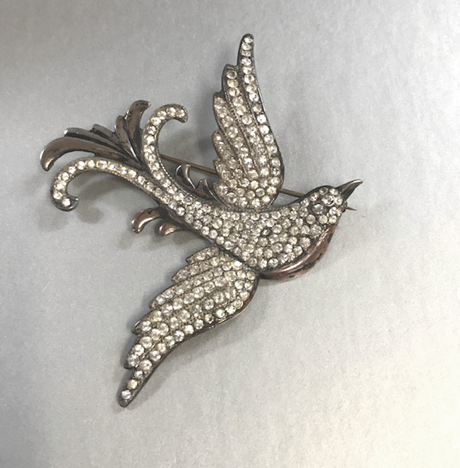 GOLDSTEIN-POLAND bird brooch of sterling set with clear rhinestones, a bird on the wing brooch