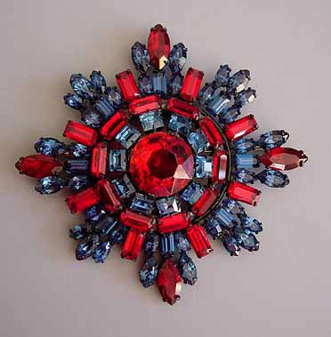 STARBURST brooch in red and blue rhinestones, a large dazzling brooch in a japanned setting, circa 1950