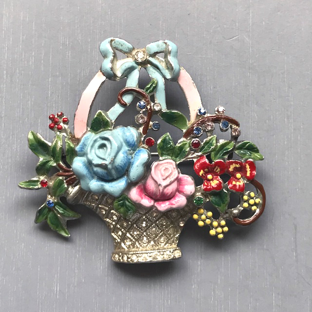BASKET brooch with colorfully enameled flowers and clear rhinestones set in white metal