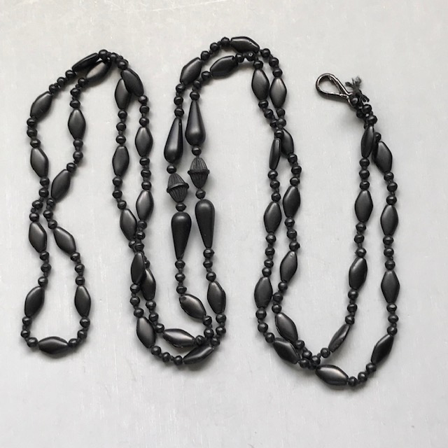 VICTORIAN black glass 56″ long muff or lorgnette chain with very unusual “watermelon seed” or “crepe stone” beads, 56″