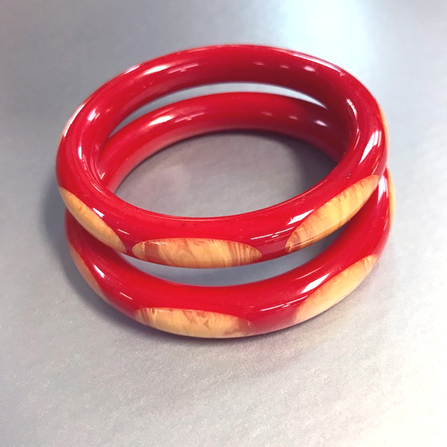 SHULTZ bakelite red spacer tube bangle with cream colored marbled oval dots