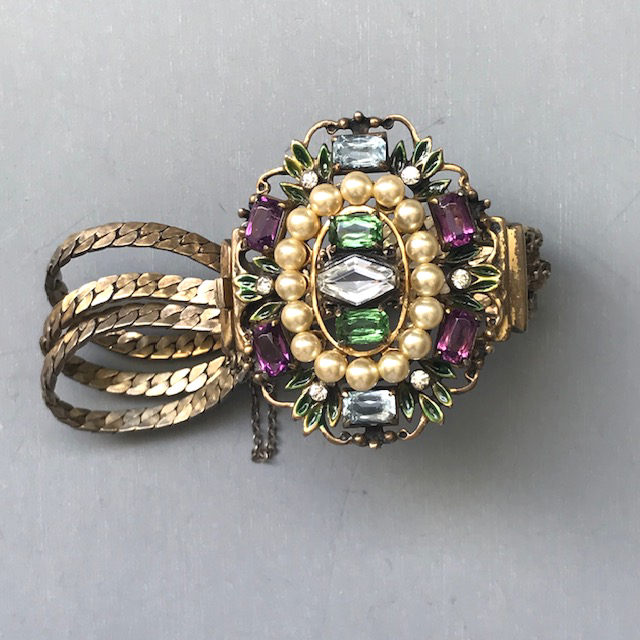 DEROSA bracelet in gold washed sterling with purple, pale blue, green and clear rhinestones and glass pearls and accented with tiny green enameled leaves